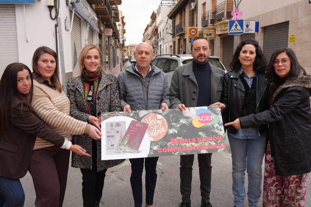 Representantes del Ayuntamiento de Peligros, miembros de ACEP y comerciantes locales durante la presentación oficial de la campaña “La Tarjeta que Multiplica tu Ilusión”, en una de las principales vías comerciales del municipio.